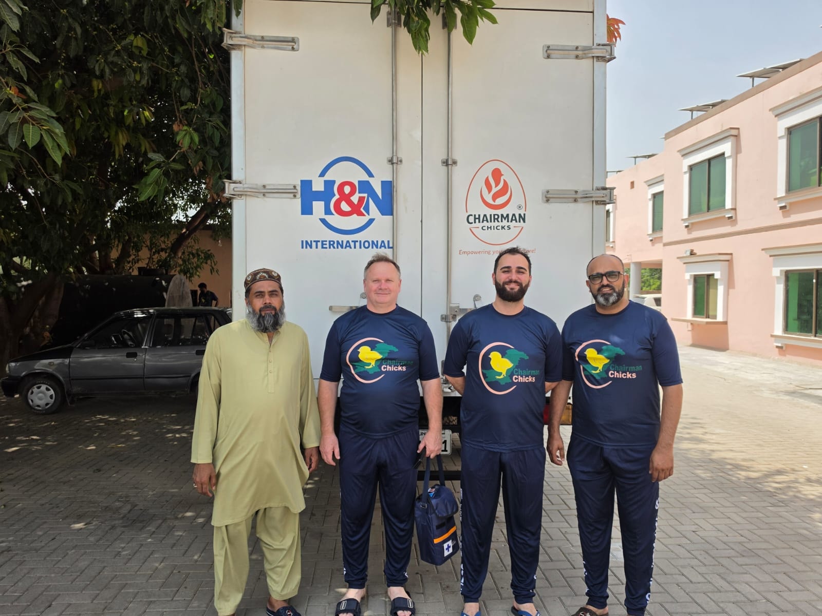 H&N International representatives with Chairman Chicks team in front of H&N branded transport vehicle
